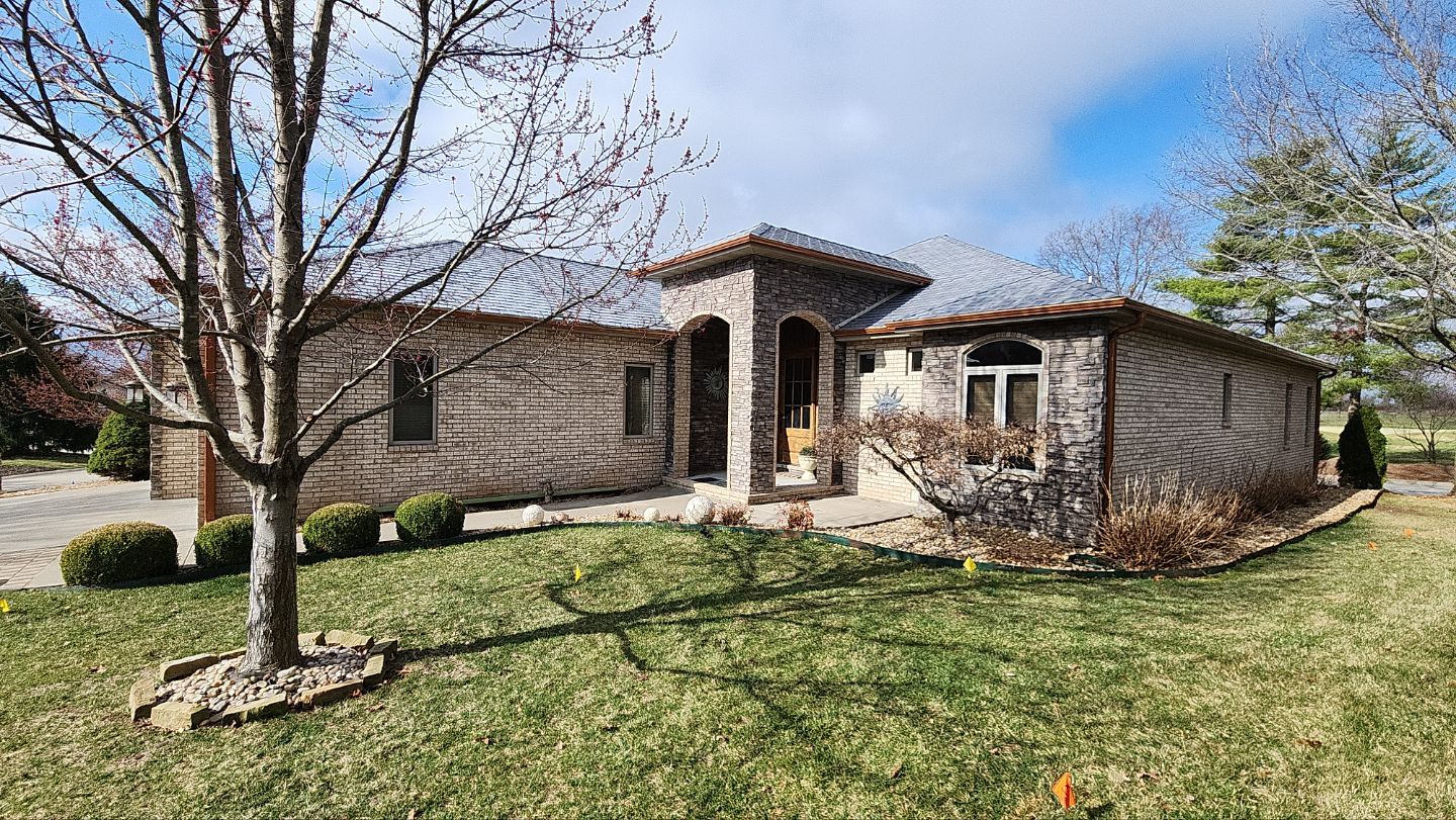 Finished ARCC residential roofing project on a brick and stone home in Southwest Missouri