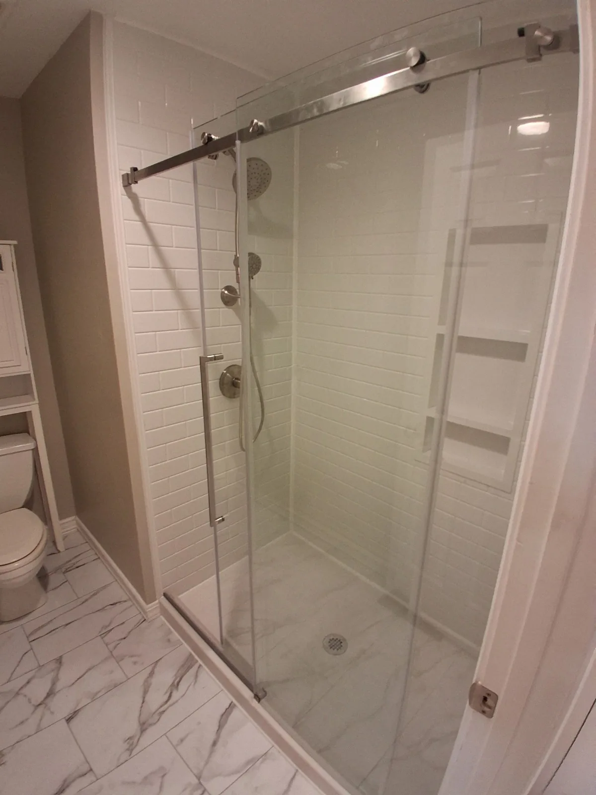 Completed ARCC bathroom remodel with a glass shower enclosure